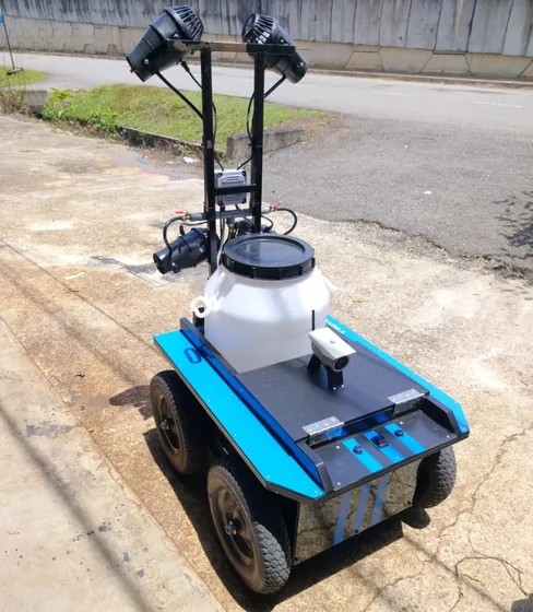 Our current prototype: a wheeled sprayer with a white tank, fan misters and a deck camera