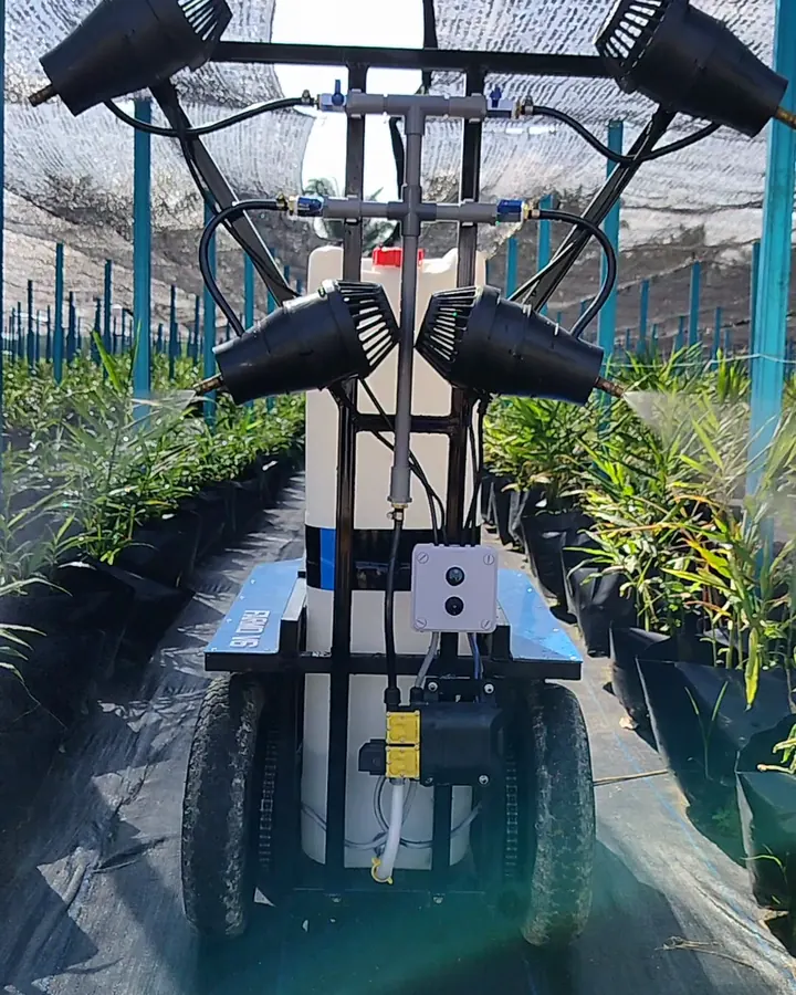 Our wheeled sprayer in a ginger row under shade netting